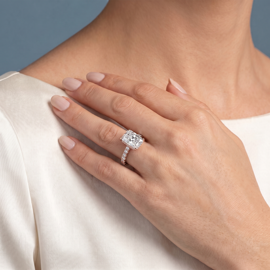 18 KT Rose Gold Radiant Cut Diamond Solitaire Ring with Hidden Halo and French Pave Band - worn close-up
