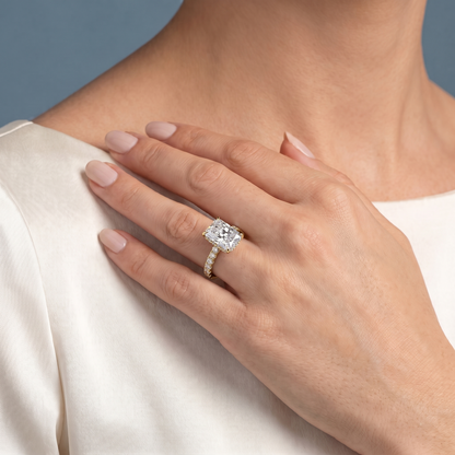 18 KT Yellow Gold Radiant Cut Diamond Solitaire Ring with Hidden Halo and French Pave Band - worn close-up