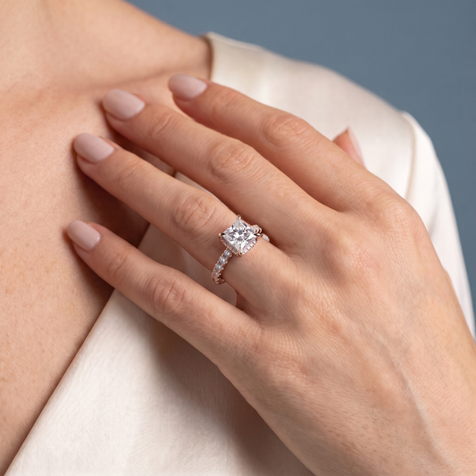 18 KT Rose Gold Princess Cut Diamond Solitaire Ring with Hidden Halo and French Pave Band - worn close-up