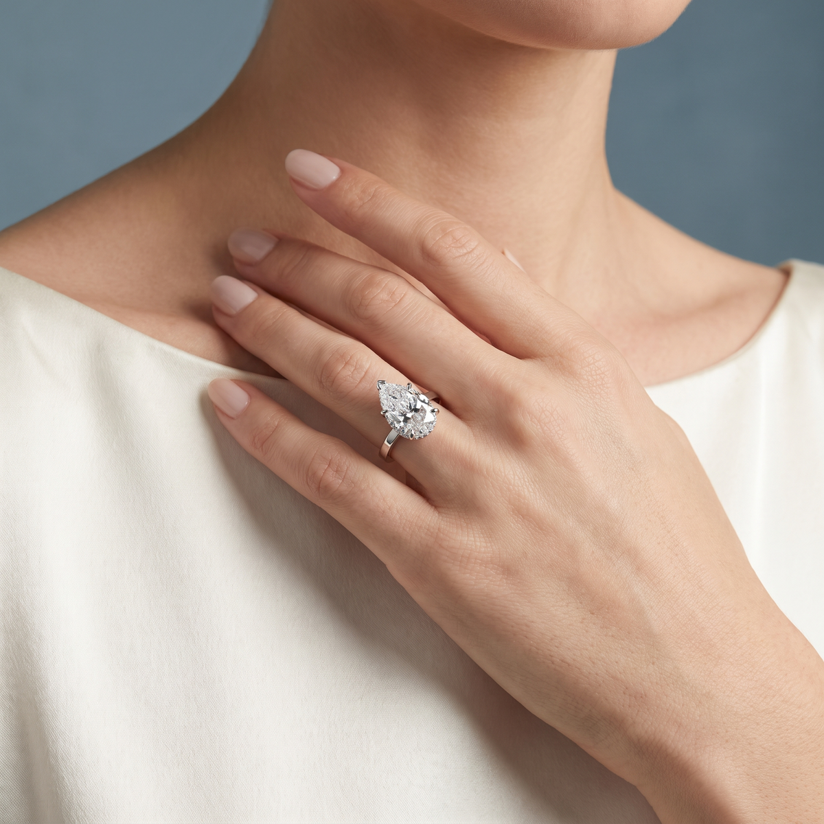 Platinum Pear Cut Diamond Solitaire Ring with Pave Collar - worn close-up