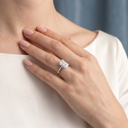 Platinum Emerald Cut Diamond Hidden Halo Solitaire Ring - worn close-up
