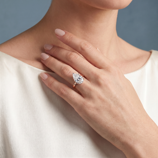 18 KT Rose Gold Pear Cut Diamond Solitaire Ring with Hidden Halo - worn close-up