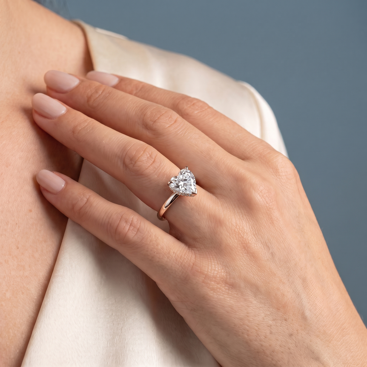 18 KT Rose Gold Heart Cut Diamond Hidden Halo Solitaire Ring - worn close-up