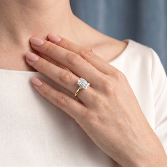 18 KT Yellow Gold Emerald Cut Diamond Hidden Halo Solitaire Ring - worn close-up
