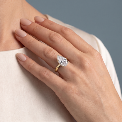 18 KT Yellow Gold Pear Cut Diamond Hidden Halo Solitaire Ring - worn close-up