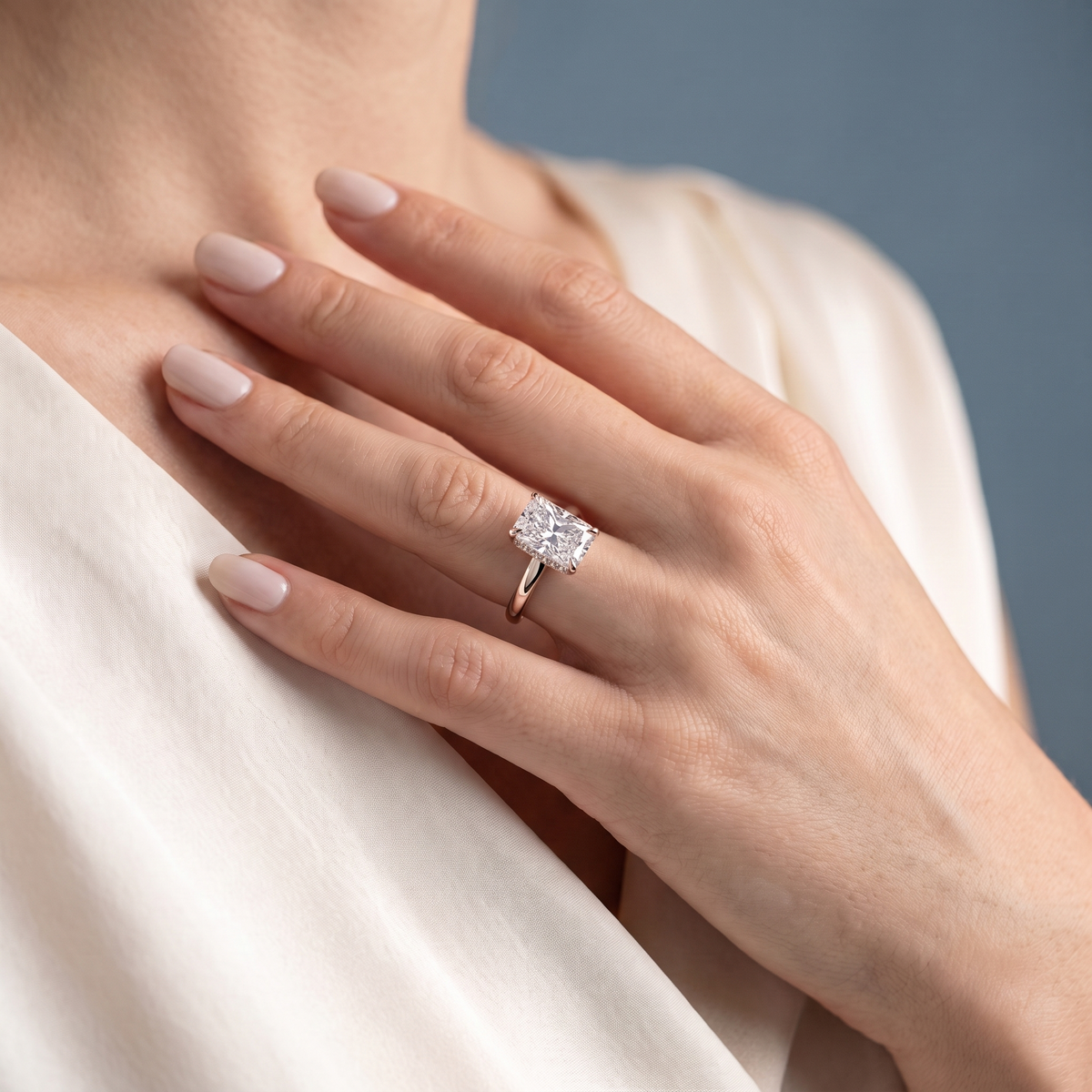 14 KT Rose Gold Radiant Cut Diamond Hidden Halo Solitaire Ring - worn close-up