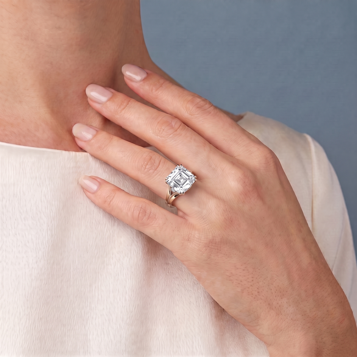 18 KT Yellow Gold Asscher Cut Diamond Solitaire Ring with Hidden Accent Basket - worn close-up