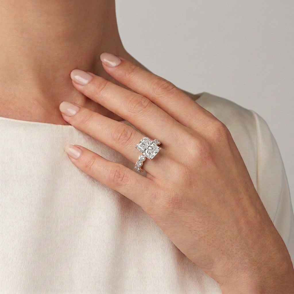 14 KT Rose Gold Radiant Cut Diamond Ring with Shared Prong Eternity Band - worn close-up