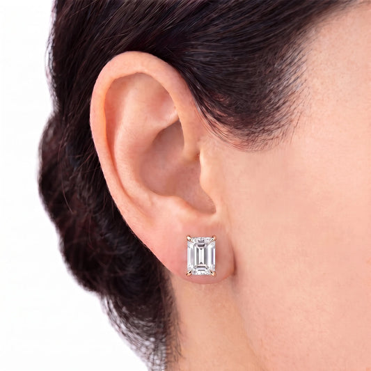 Emerald cut tiger-prong diamond stud earring in rose gold worn on ear